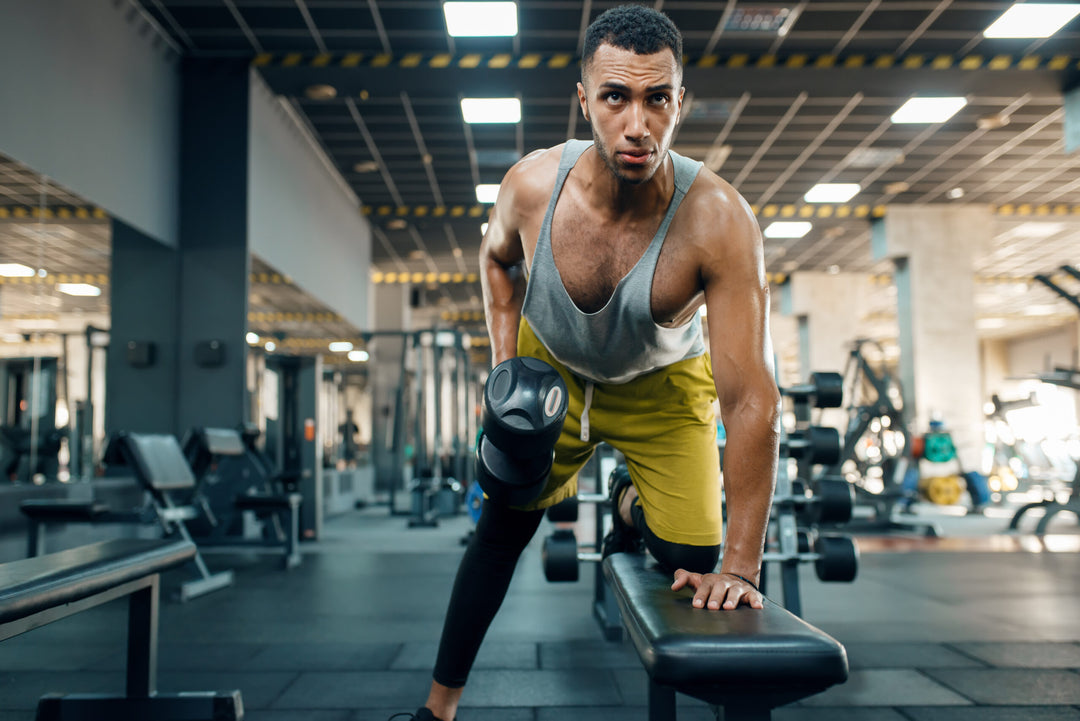 Athlete doing exercise with dumbbells on the bench