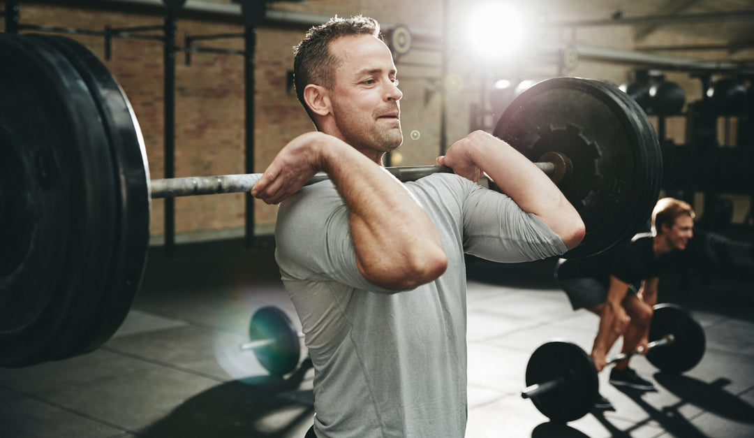 Fit man doing weight training at the gym