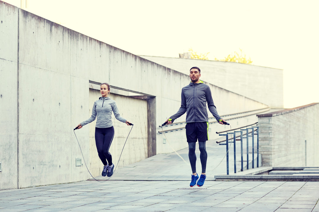 man and woman exercising with jump-rope outdoors